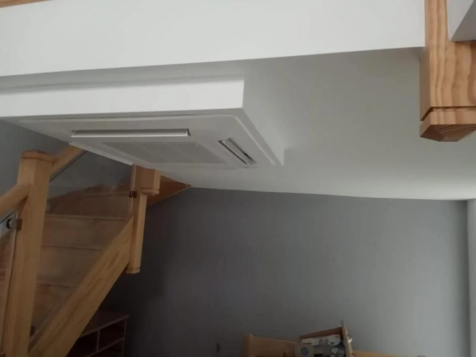 White ceiling cassette air conditioner fitted in a ceiling